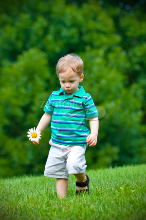 Boy walking with flower